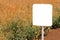 Blank mockup sign board in ripe rapeseed crop field