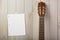 blank musical page stuck wooden wall with guitar s head. High quality photo