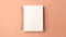 A blank notebook on a peach colored surface, peach fuzz, trendy color of the year 2024.