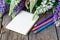 Blank notebook with pen and bouquet of flowers wooden table. diary writing concept