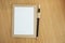 Blank notebook with pencil on wooden table background. top view and copy space for your text