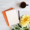 a blank notebook surrounded by yellow peony flower, coffee cup and pen, a light wooden background, To-do list, plans