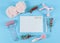 Blank notebook, wooden numbers 2022, fir branches, pink massager, candle, fluffy headband and pen lie on blue.