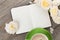 Blank notepad, coffee cup and white rose flowers