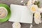 Blank notepad, coffee cup and white rose flowers