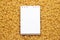 Blank notepad on uncooked macaroni background