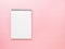 Blank notepad white page on pink desk, color background. Top vie