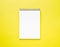 Blank notepad white page on yellow desk, color background. Top v