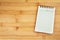 Blank notepad on wooden table , overhead shot or Top view