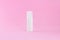 Blank packaging cosmetic pump bottle on pink background, close up mockup cream spray object