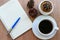 Blank page of note book with black coffee cup, cactus, pine cones