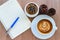 Blank page of note book with Latte art coffee cup, cactus, pine cones