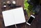 Blank page of open notebook and decor items on rustic wooden table.