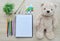 Blank paper, color paint and bear doll on the wood table - Top v