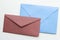 Blank paper envelopes on marble flatlay background, holiday mail letter or post card message design