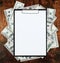 Blank paper sheet in clipboard placed on center of money dollar and old wood background. Business plan and other information conce