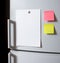 Blank paper sheet on fridge door