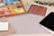 Blank paper, soft pastels and other drawing supplies on wooden table at artist`s workplace. Space for design