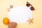 Blank paper  sunglasses  exotic fruits  seashells and starfish on yellow background. Concept of summer vacation