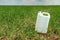 Blank pesticide jug container mock up in wheatgrass field