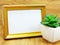 Blank photo frame and artificial plant
