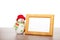 Blank photo frame and christmas snowman on wooden table