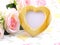 Blank photo heart wood frame with pink roses and gift box on sweet flower