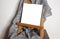 Blank picture on easel with gray drapery. Place to insert a picture