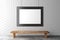 Blank picture frame on brick wall with wooden bench on concrete