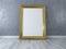 Blank picture with gold frame standing on floor. Design Template for Mock Up