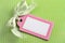 Blank pink tag on green