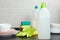 Blank plastic bottle with liquid dishwashing detergent on kitchen table