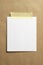 Blank polaroid photo frame with soft shadows and yellow scotch tape on craft cardboard paper background as template for graphic