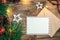 Blank postcard, envelope and Christmas decor on wooden background, copy space.