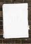 Blank poster atop of many other layers of paper pasted onto a br