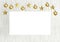 Blank poster with hanging golden balls and stars ornaments on white wooden background