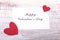 Blank present Valentine card on wooden background