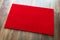 Blank Red Welcome Mat On Wood Floor Background Ready For Your Text