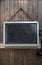 Blank rustic blackboard hanging on wooden door