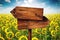 Blank Rustic Opposite Direction Wooden Sign in Sunflower Field