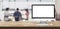 Blank screen desktop computer on wooden table top with blur people working at creative office bokeh background,Mock up for