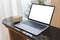 Blank screen laptop computer modern man use room laptop with blank white desktop screen with coffee cup on wooden table in cafe