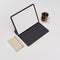 Blank screen tablet with keyboard on white table with diary book and coffee cup