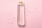 Blank shampoo bottle on pink background