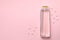 Blank shampoo bottle on pink background space for text