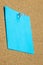 Blank sheet of blue paper on a bulletin board