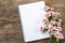 Blank sheet of notebook and red and white carnation