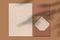 Blank sheet of paper and letter against brown background. Envelope. Writing notes concept. Top view. Horiontal shot. Empty space