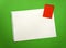 Blank sheet of paper space for design and lettering on a beautiful green background red notepad sheet. Perforated sheet torn from