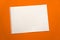 Blank sheet of paper space for design and lettering on a beautiful orange background. A sheet of perforated paper torn from a